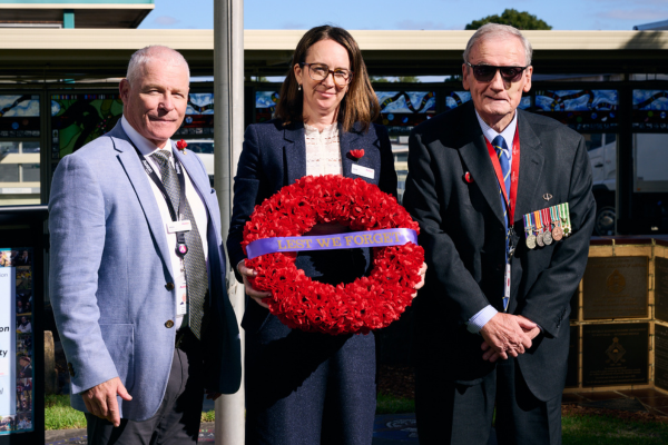 Jodie with Ross and a veteran, holding a wreath